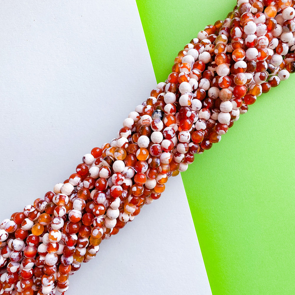 8mm Faceted Red and White Spotted Carnelian Rounds Strand