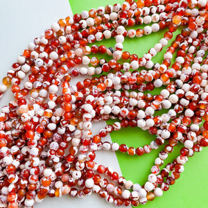 8mm Faceted Red and White Spotted Carnelian Rounds Strand